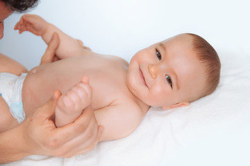 Doctor massaging a cute baby