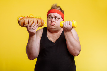 Fat funny man choise between sport and fastfood