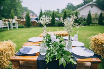 Wet dinner table with dishes after the rain