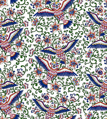 Seamless pattern with decorative birds and flowers. Folk ornament in bright red, green, blue and yellow colors on the white background. Vector illustration.
