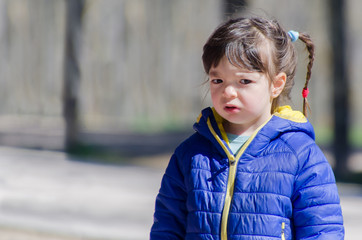 Portrait of a despaired little girl with unhappy expression