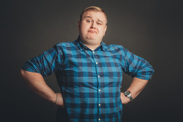 fat proud young man on black background