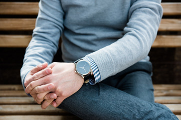 Stylish man in gray jumper, elegant business man's hand with fas