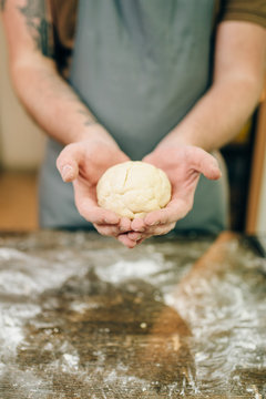 Homemade pasta cooking, male hands with dough