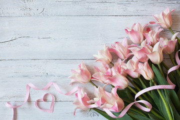Pink tulips on a wooden background