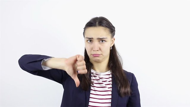 Sad young woman showing thumbs down