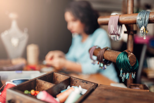 Needlework tools, master at workplace in workshop