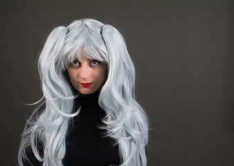 A woman in a beautiful Park gray-blue color. The woman is wearing a black jacket.
