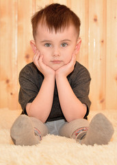 Serious little boy sitting