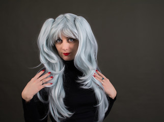 A woman in a beautiful Park gray-blue color. The woman is wearing a black jacket.
