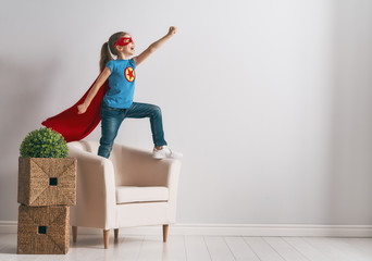 child is playing superhero