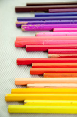 wooden colored pencils on white texture