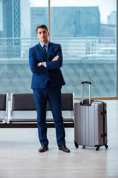 Businessman waiting at the airport for his plane in business cla