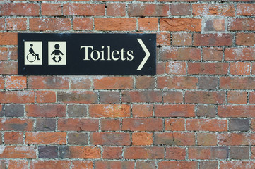 disabled Toilet and baby changing sign on wall