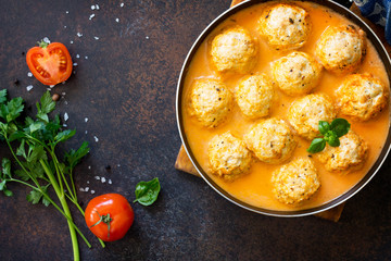 Meat balls turkey in tomato sauce, home cooking on a stone or slate background. Copy space, top view flat lay background.