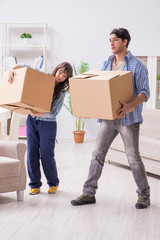 Fototapeta na wymiar Young family moving in to new apartment after paying off mortgage