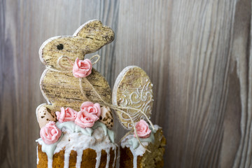 Easter. Gingerbread in the form of a rabbit with sugar roses in the form of an ornament on an Easter cake
