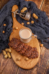 Still life with tea, biscuits, nuts and an antique walnut. Light delicious breakfast on a wooden table, top view.