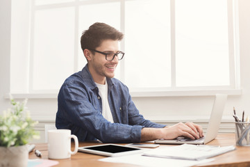 Young businessman working with laptop in office