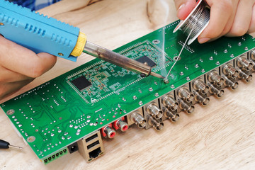 Soldering an electronic circuit board.