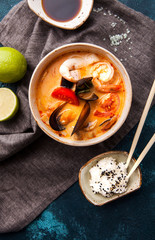 Japanese tom-yam soup with seafood and rice, chopsticks and lime - 198852500