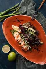 a beautifully served Japanese salad with asparagus, shrimps and lettuce leaves - 198852553