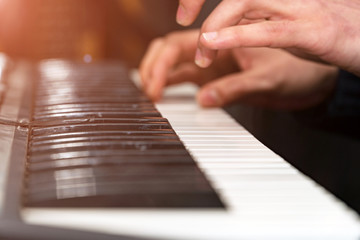 Fototapeta premium Hands of a pianist close-up. Plays on the synthesizer