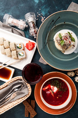 Lunch of three dishes, vegetable sushi rolls, soup and mashed potatoes with meat - 198852783
