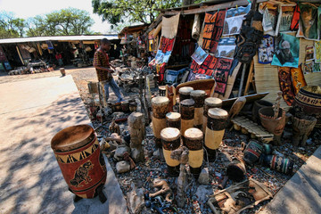 VICTORIA FALLS, ZAMBIA - NOVEMBER 12.2007:, Rich offer of souvenir at  marketplace, August 12. 2007  Victoria falls, Zambia - obrazy, fototapety, plakaty