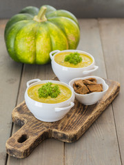 pumpkin puree soup on a wooden table. 