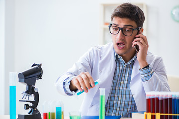 Young chemist student working in lab on chemicals