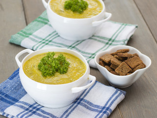 pumpkin puree soup on a wooden table. 