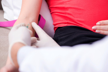 Pregnant woman patient visiting doctor for regular check-up