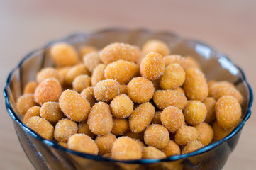 Peanuts in a paprika flavoured in bowl.