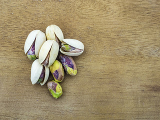 pistachios roasted on a wooden table. Copy space.