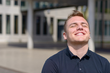 Happy attractive man enjoying the spring sunshine