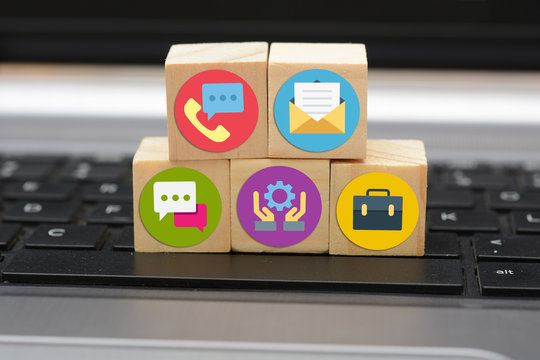 Contact Us business Icons on wooden blocks on keyboard
