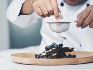 smart master chef decoration brownie cake with fresh blueberry.