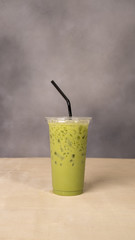 Ice tea or ice coffee with milk on wood background.