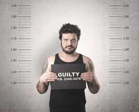 Caught guilty man with ID signs on his hand.