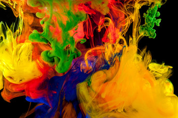 Abstraction of mix multicolored paints in water on a black background