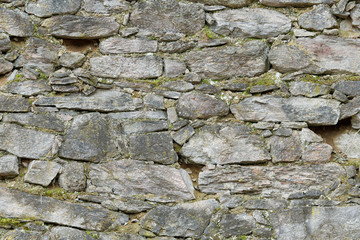 Old stone wall with scratches as texture