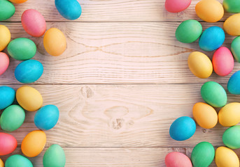 Easter background with Easter eggs and spring flowers. Top view with copy space.