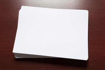 White business card on wooden table. Blank portrait A4.