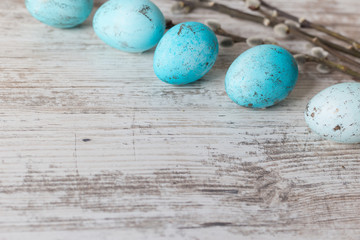 Blue Easter eggs on white old table. Concept of Easter and spring