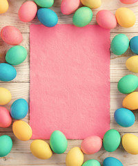 Easter background with Easter eggs and spring flowers. Top view with copy space.