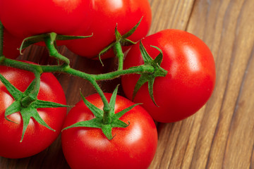 ripe tomatoes on wood background