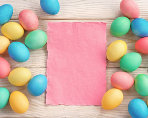 Easter background with Easter eggs and spring flowers. Top view with copy space.
