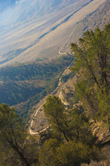 Mountain pass, from which the clouds over the valley can be seen, in the Sierra Nevada, California, USA. The Sierra Nevada is a mountain range in the Western United States.