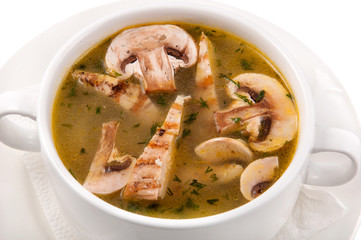 a plate of soup on a white background